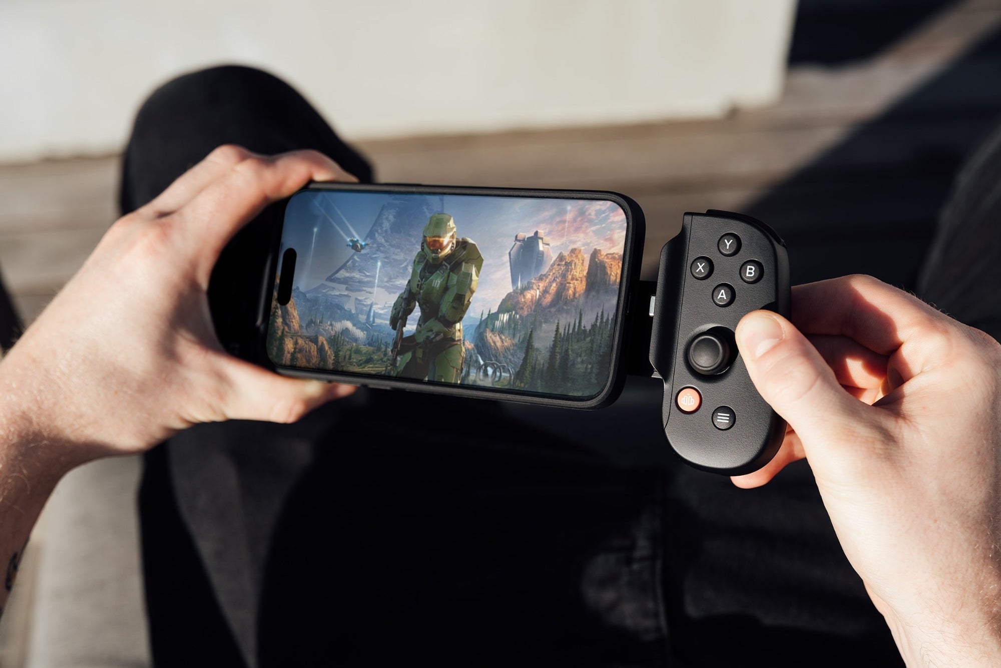 player's hands holding backbone device