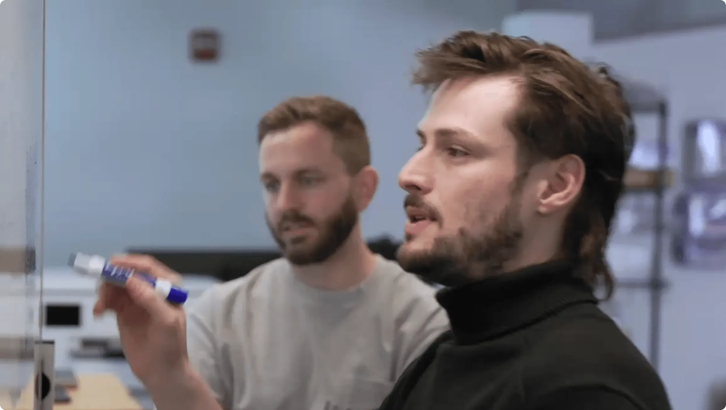 2 engineers in front of the board